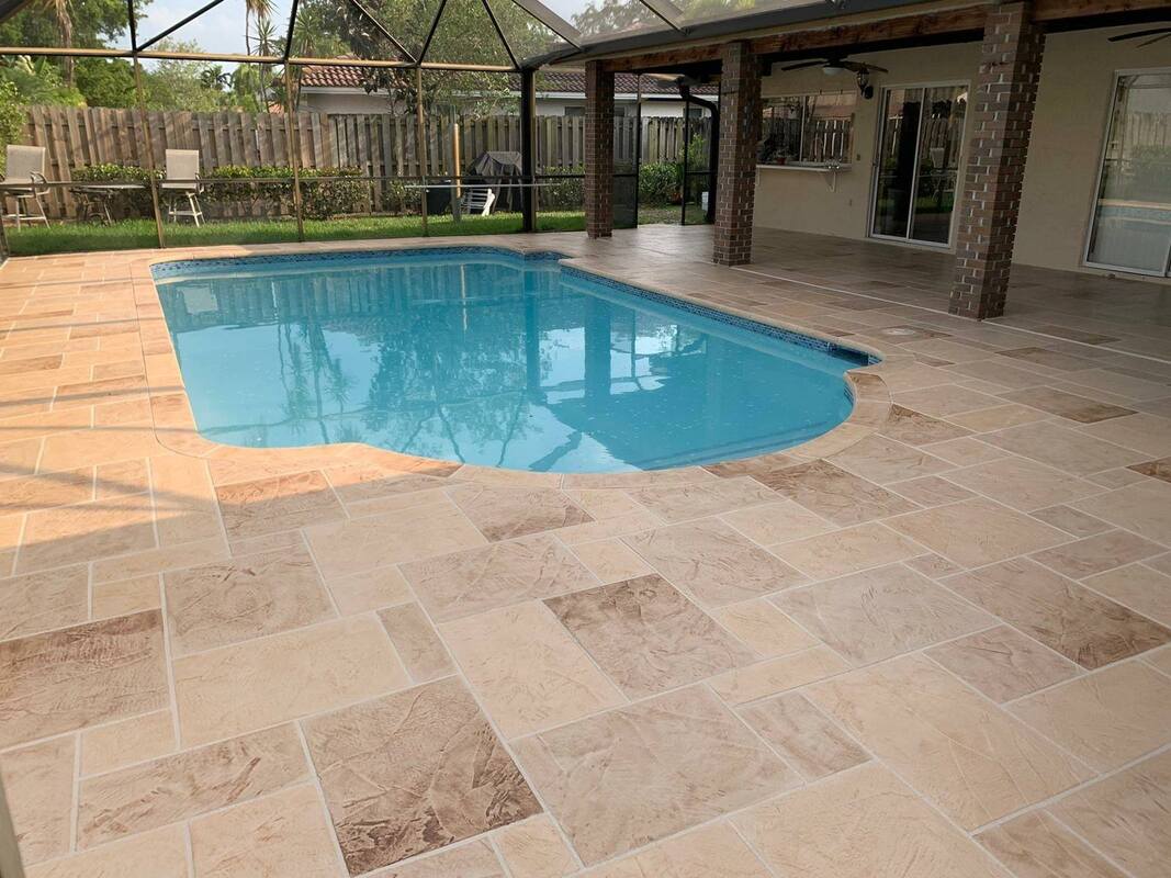 beautiful contemporary patio and pool deck overlooking pool.  located in ft lauderdale, florida.